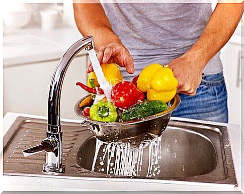 a man washes away pesticides from vegetables