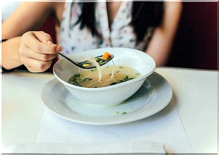 woman eating soup